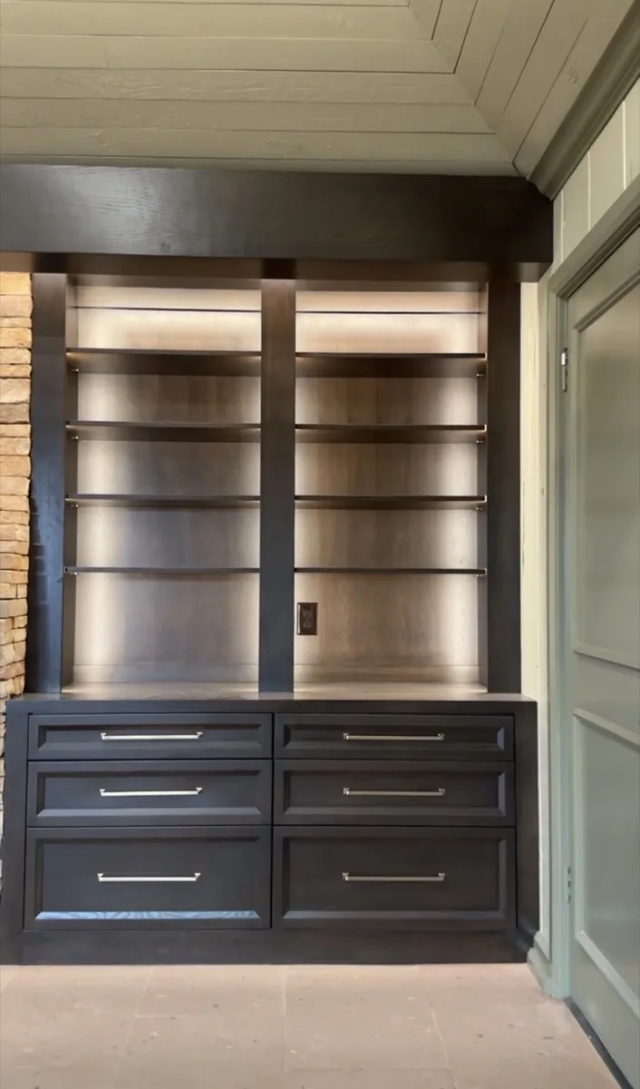 Arched wood-framed glass door with sconce lighting in an OKC home
