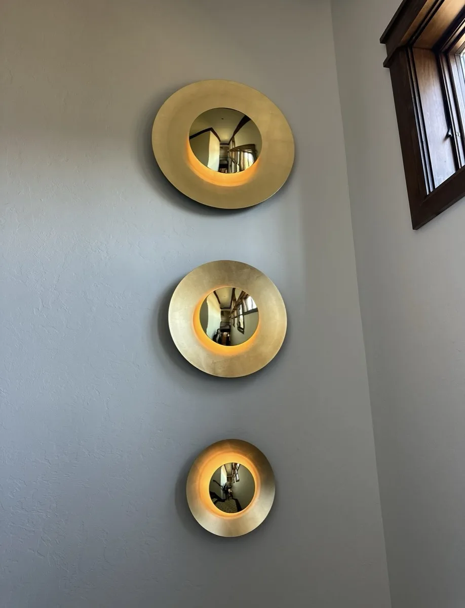 Brass convex disc sconces installed in an OKC home