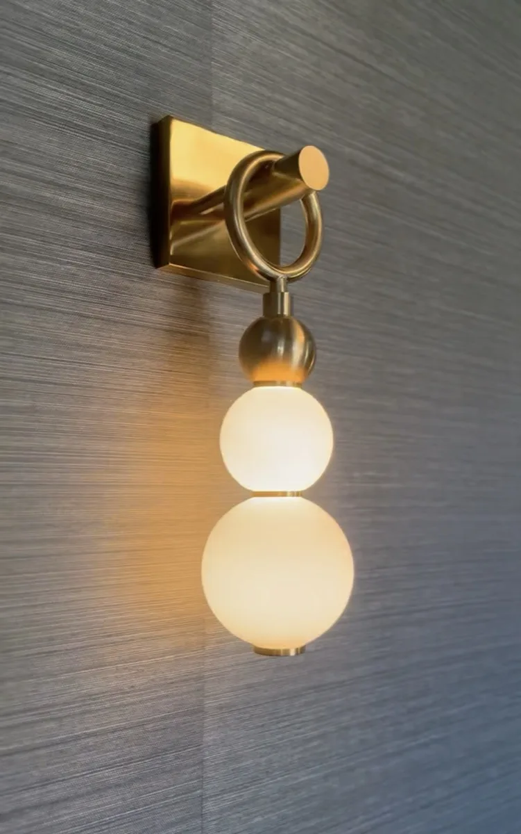 Brass double-globe wall sconce in a home