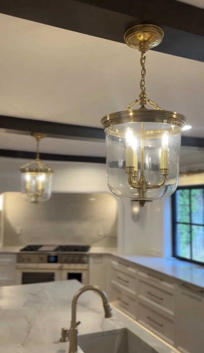 Brass round mirror sconces in a stairwell