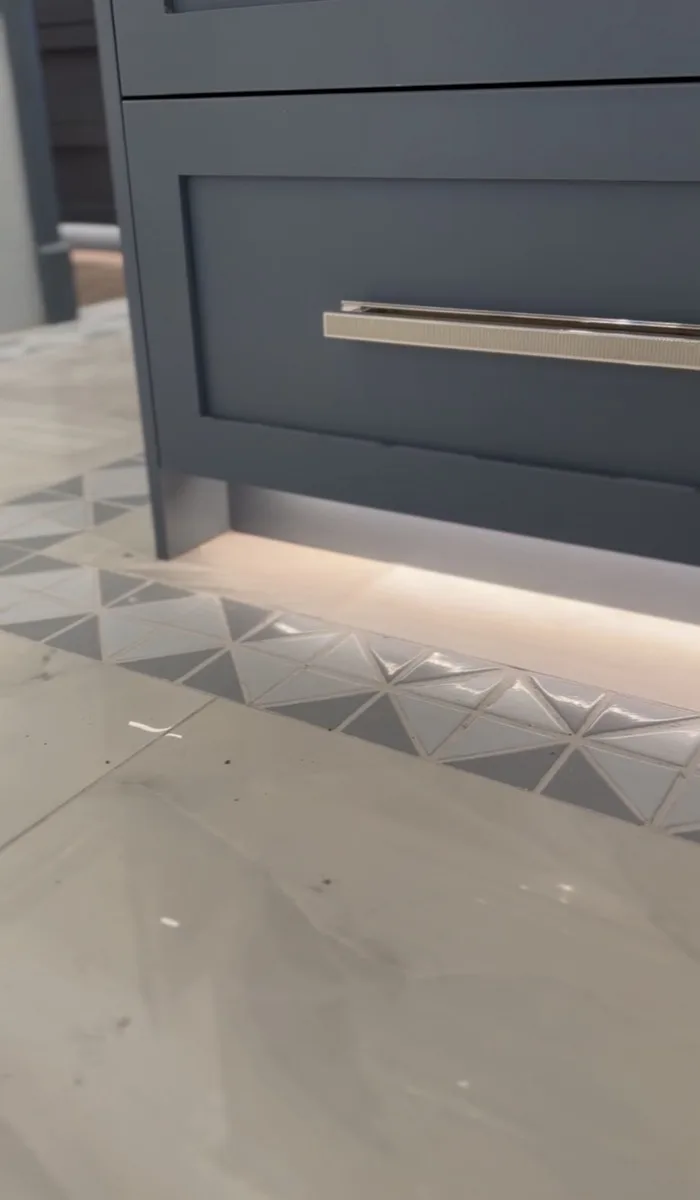 Cabinetry hardware and lighting detail in a home