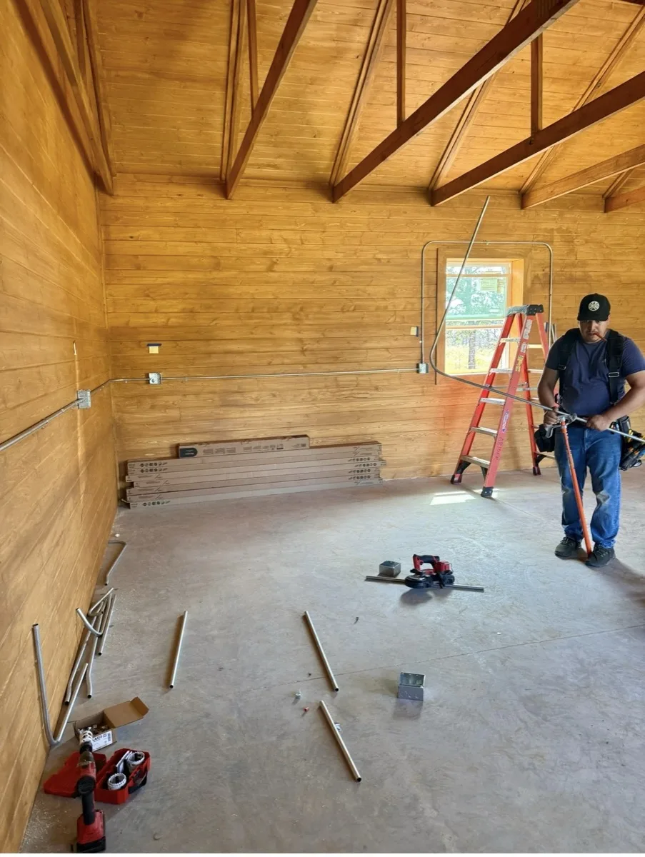 Grider Electric electrician running conduit during new construction