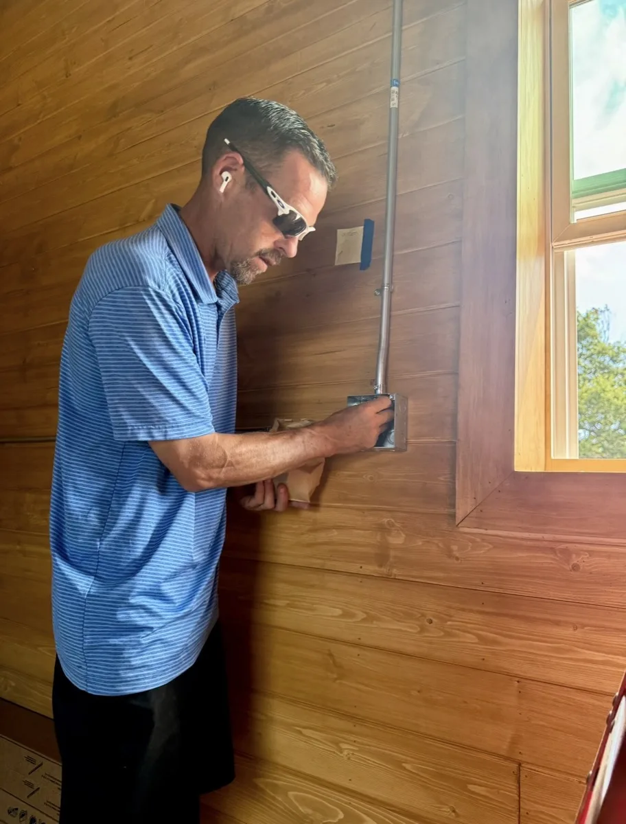 Grider Electric electrician installing an outlet in a home