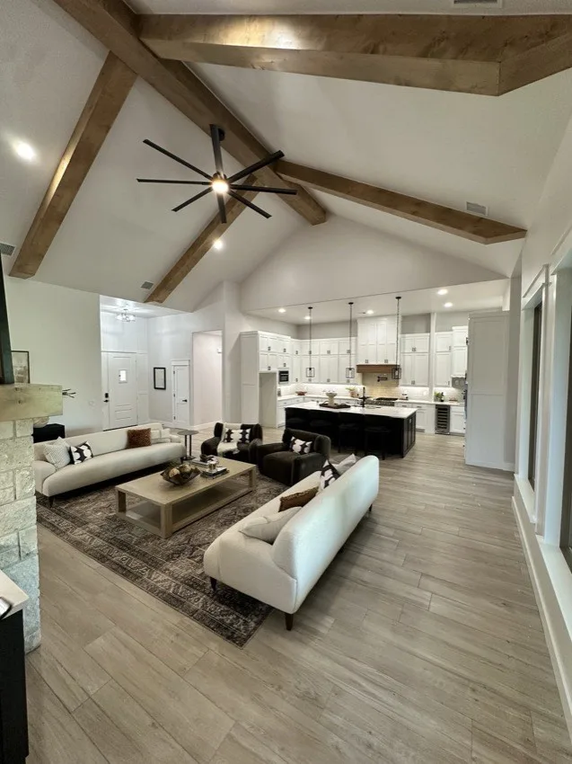 Modern black ceiling fan on a vaulted wood-beam ceiling in an Oklahoma City home