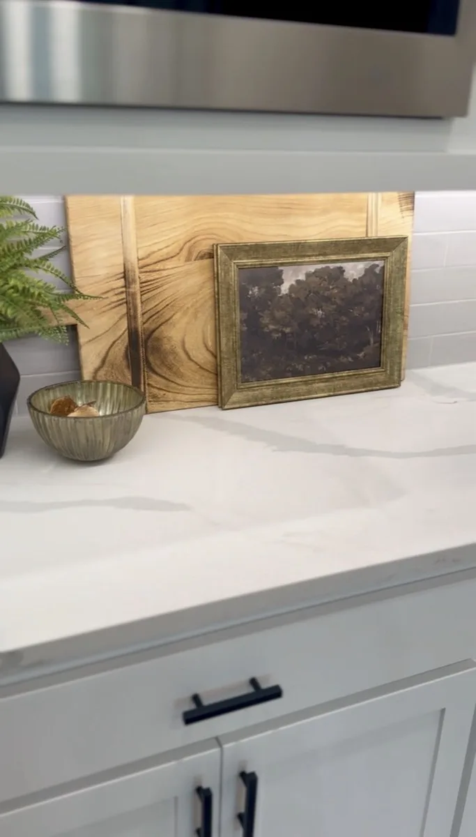 Framed art and lighting detail on a kitchen counter in an OKC home