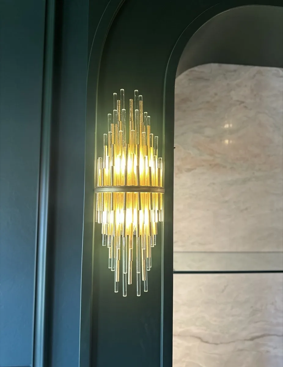 Gold rod wall sconce in a home archway