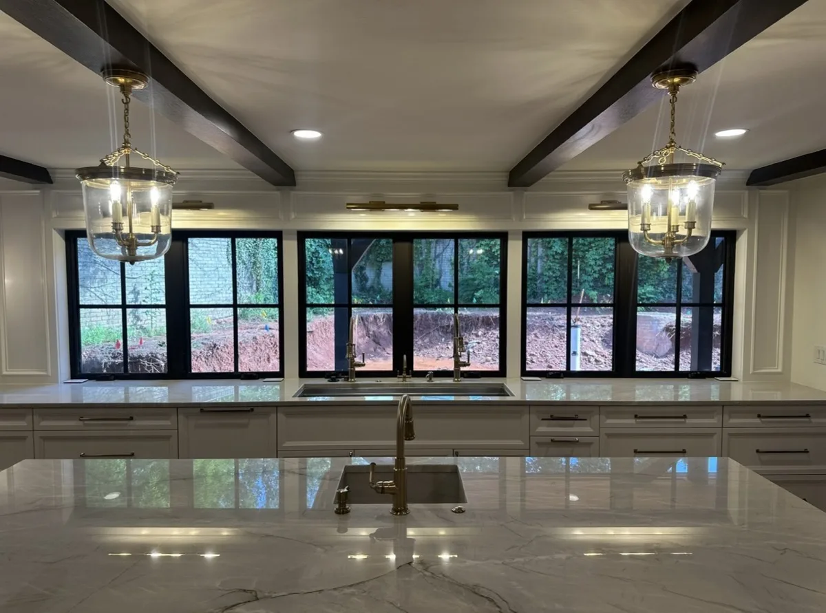 Arched cabinetry with brass hardware and accent lighting in an OKC home