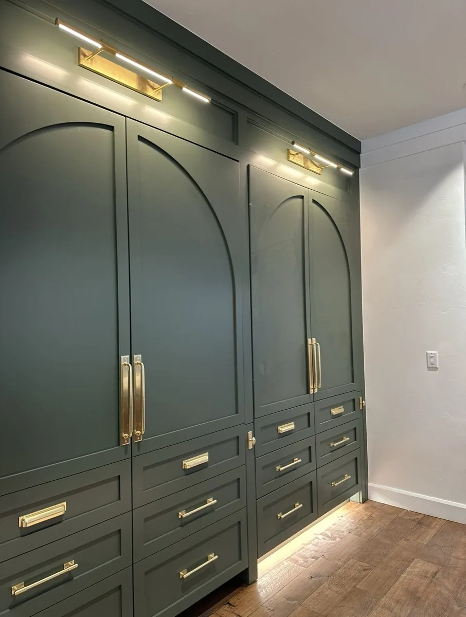 Arched cabinetry with gold accent lighting in a home
