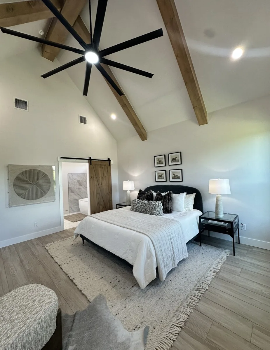 Primary bedroom with wood beam ceiling in a home
